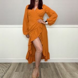 Orange wrap dress with frill and sleeves.